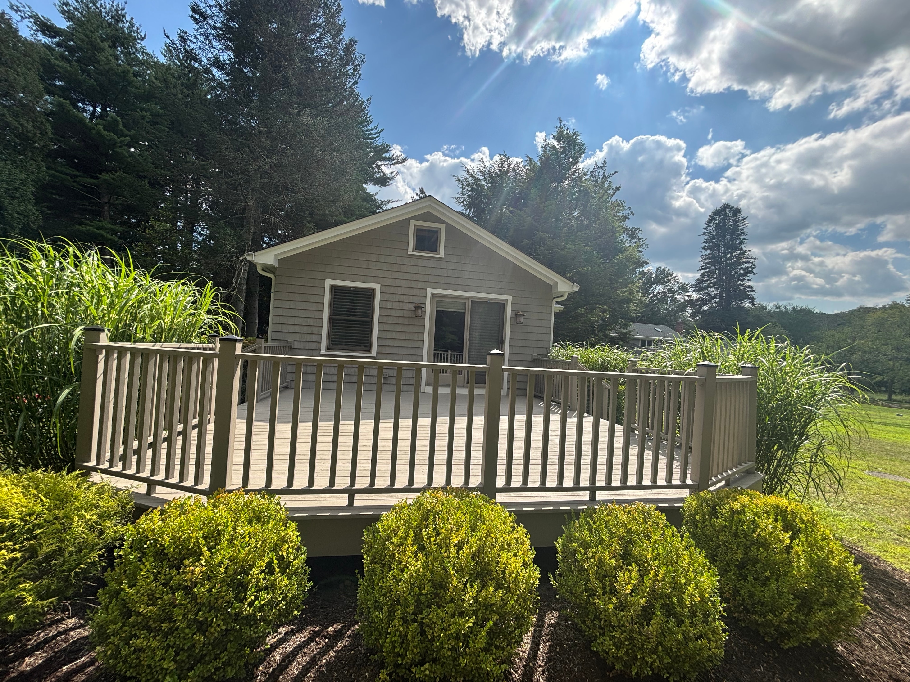 Beautiful deck with professional landscaping and green bushes